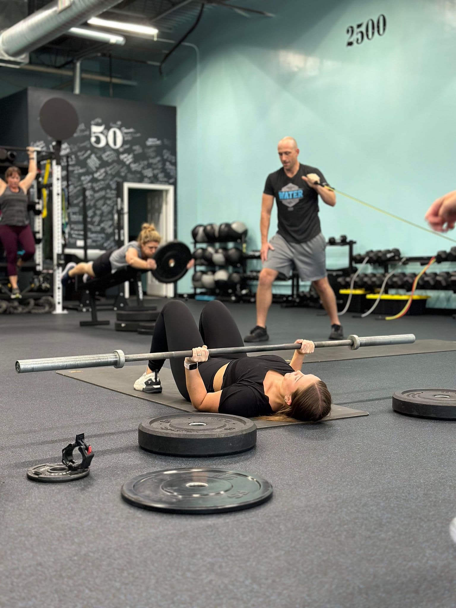 Barbell floor press with a trainer